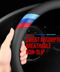 Close-up of BMW Nappa Leather Steering Wheel Cover Slim Fit With Three Color Stripe Design held by a hand, showing breathable texture.