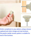 10 Pack Handcrafted Ceramic Cabinet Knobs Featuring Gorgeous Granite Marble Finish, shown in use on cupboard door.