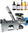 Semi Automatic Label Applicator For Round Bottles, Heavy Duty Bottle Tagger With Instant Date Encoder, Cans And Glass Roller, Precision Labeler Built To Last And Operate Like A Boss on a workshop table.