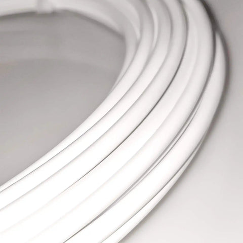 Close-up of white coil from Lined Bicycle Derailleur Cable Housing Kit With 4mm Inner Wire, 50 Ft Roll, 50 End Caps, Compatible With SRAM And Shimano Mountain And Road Bikes, DIY Install, Durable Taiwan Made, Great For Quick Gear Fixes
