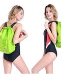 Model wearing green Dry Wet Separated Swim Bag With Drawstring Backpack, Waterproof Gym Pool Beach Gear Tote, 36x40cm, adjustable straps.