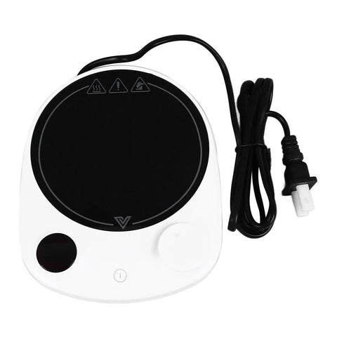 This Solid Electric Mug Warmer Boasts Four Heat Presets To Keep Your Daily Brew Piping Hot All Day Long Featuring Smart Auto Shut Off Protection And Fast Heating With A Sleek White Top For Desk Setup, shown from the top with a black heating surface and cord.