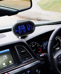 MASO car digital clock with thermometer and voltmeter, blue backlit LCD, 12–24V powered, mounted on dashboard.