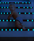 Baby on stairs with Night Sky Glow Stars Ceiling Stickers Kit With 1049 Pieces Including Moon And Stars, Self Adhesive Wall Decals