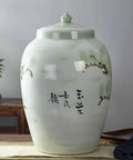Total Pantry Flex That Keeps Grains Sealed Tight This Large Green Ceramic Rice Jar with floral design for kitchen storage.
