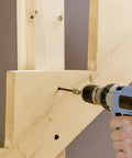 Person drilling with 4 Inch Timber Framing Nails 250 Count Pro Grade Heavy Duty ACQ Safe And Corrosion Resistant Tapered Head