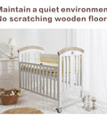 Crib with 2 Inch Non Marring Rubber Caster Wheels 4 Pack With Brakes in a nursery room