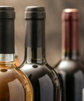 Premium Pvc Heat Shrink Wine Bottle Caps With Hella Bright Color Options on wine bottles, showcasing sleek black caps for home winemakers.