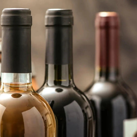 Premium Pvc Heat Shrink Wine Bottle Caps With Hella Bright Color Options on wine bottles, showcasing sleek black caps for home winemakers.