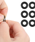Close-up of a hand holding a black silicone temple grip from the Six Piece Eyeglass Repair Kit With Glasses Temple Grips And Silicone Hinge Tighteners To Give Your Specs A Solid No Sweat Grip Plus Compact Screwdrivers For A Breeze Quick Fix That Works Like A Charm All Day.