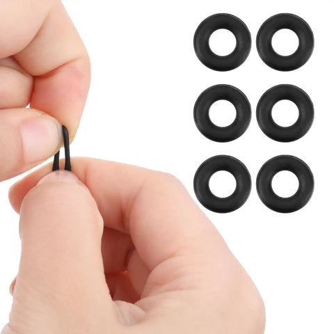 Close-up of a hand holding a black silicone temple grip from the Six Piece Eyeglass Repair Kit With Glasses Temple Grips And Silicone Hinge Tighteners To Give Your Specs A Solid No Sweat Grip Plus Compact Screwdrivers For A Breeze Quick Fix That Works Like A Charm All Day.