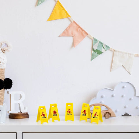 Ultimate Boss Set Of 12 Mini Wet Floor Signs Rad Tiny Yellow Caution Sign For Safety Fun And Doll Play With Durable Plastic Warning Tags game displayed on a shelf.