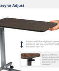 Heavy Duty Adjustable Overbed Table With Dead Simple Height Changes Non Tilt Wood Grain Top And Smooth Rolling Swivel Casters For Zero Hassle Room Moves, adjustable height feature with textured top.