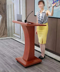 Rock Solid Wood Roll Away Lectern With Plenty Of Storage Space, 115cm high, used during a presentation in a classroom setting.