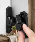 Sleek Black Barn Door Latch Made From Aluminum Alloy Supporting 90 And 180 Degree Swivel, installed on a door with a hand adjusting it.