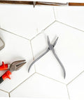 Stainless Steel Eyeglasses Repair Tool With Angled Pliers for Adjusting Frames on tiled surface
