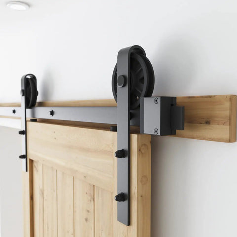 Built Like A Tank 7 Foot Sliding Barn Door Hardware Kit featuring heavy duty steel tracks and pulleys for smooth sliding.