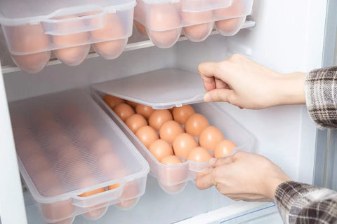Covered Egg Holder For Fridge That Keeps Up To 18 Eggs Fresh, Heavy Duty Plastic Egg Storage Organizer, Pack Of 4, in use inside a fridge.