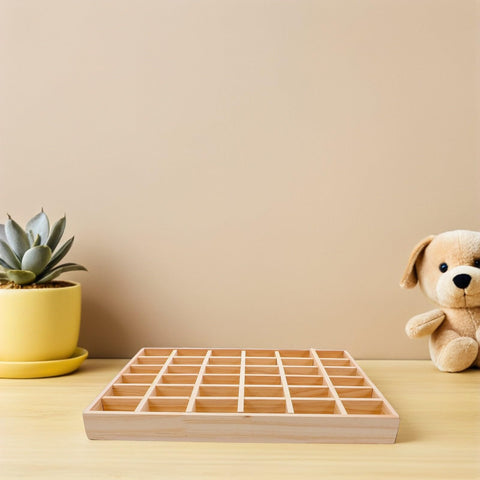 Top Tier Solid Wood Jewelry Tray Organizer Designed To Keep Your Bling Neatly Arranged In 36 Grids on a wooden table with a plant.