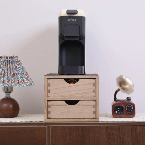 Double Tier Wooden Coffee Maker Stand With Pull Out Storage Drawer For K Cups And Capsules Countertop Brew Organizer Rack on a table next to a lamp.