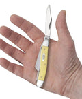 Dang Tough Yellow Synthetic Handle Stockman Pocket Knife With Clip Spey And Sheepfoot Chrome Vanadium Steel Blades held in hand.