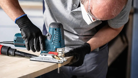 Person using a jigsaw with Pro Gear Tear Free Jigsaw Blades T Shank T 308 Bo on wood for smooth cuts.