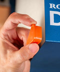 Person holding an orange component next to the Compact Ceiling Air Filtration Unit With Heavy Duty Triple Stage Filters.