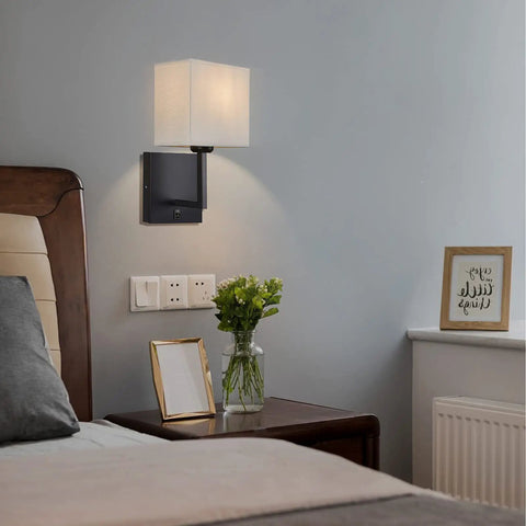 Hardwired Modern White Fabric Wall Sconce Dual Switch On Off Indoor Lighting for Bedroom beside a bed with nightstand