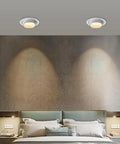 Two UWYTGF 10 Pack 4.5 Inch Gimbal Led Recessed Lights illuminating a stylish bedroom wall with adjustable focus.