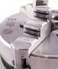 Close-up of 80mm 3 Jaw Self Centering Mini Lathe Chuck K01-80B showing hardened steel jaws for woodworking machines.