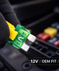 60 Piece Tough As Nails Led Blade Fuse Assortment showing green and yellow fuses held with a gloved hand for automotive use.