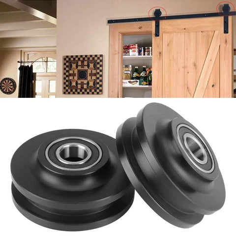 Rock Solid Barn Door Wheels With Silent Nylon Rollers And Heavy Duty Zinc Alloy Sliding Closet Hardware For Butter Smooth Glide close-up of black nylon wheels for barn doors