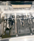 Inside view of a gas grill showing installed Three Pack Stainless Steel Heat Plates And Burners Replacement Kit for Costco Kirkland 7200108 Nexgrill 7200011 7200047U, featuring three burners and plates.