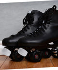 Black roller skates with 2 Pack Rubber Toe Stops For Roller Skates And Quad Skates, Round Brake Block Stoppers on wooden floor.