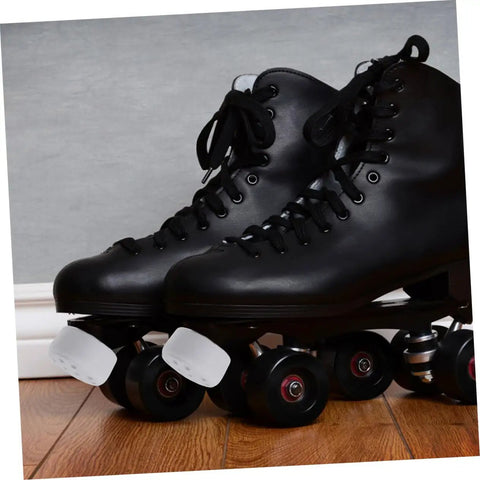 Black roller skates with 2 Pack Rubber Toe Stops For Roller Skates And Quad Skates, Round Brake Block Stoppers on wooden floor.