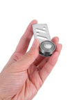 Hand holding stainless steel sliding door pulley with ball bearings, 23mm axle diameter for industrial and warehouse use.