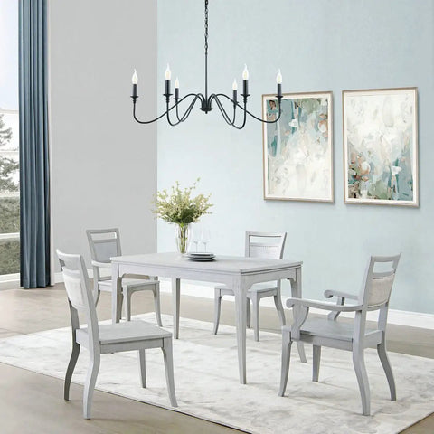 Six Light Rustic Industrial Iron Chandelier With Matte Black Finish hanging in a dining room, above a white table set.