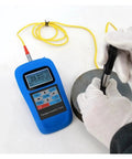 Dead On Reading Digital Leeb Hardness Tester With Beefy Metal Housing And Simple Usb Pc Hookup For Rockwell Brinell Vickers Scale Gauge Job Plus Crisp Backlit Lcd Screen Gear in use on metal surface.