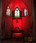 144W RGBW LED wall washer with RF control illuminating a church interior with red light, showcasing color-changing effects.