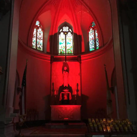 144W RGBW LED wall washer with RF control illuminating a church interior with red light, showcasing color-changing effects.
