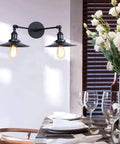 Badass Industrial Vintage Dual Light Wall Sconce Featuring Adjustable Metal Arms For Instant Room Upgrades Rock Solid Construction Easy Install In Stunning Chrome Or Sleek Matte Black Finishes Today mounted in dining area with floral decor.
