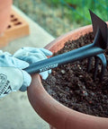 Hands using 2990 Fiberglass Go-To Garden Tool, Lightweight Yet Durable, Easy To Clean, Ergonomic Grip for soil work in potted plant