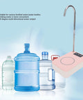 Desktop Water Dispenser Pump For 2, 3, 5 Gallon Bottles, Portable Bottle Pump with spout and pink body next to water bottles.