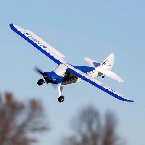 Sport Cub S 615mm RC Airplane Ready To Fly Kit in flight, white and blue, designed for beginners and hobbyists, includes battery and charger.