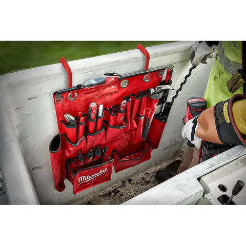 Workhorse Aerial Tool Apron In Bright Red Designed For Power Line Crews With Ample Storage Pockets holding various hand tools.