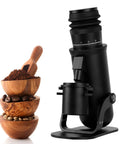 Heavy Duty Electric Burr Coffee Grinder With 48Mm Seven Star Conical Burrs And 60 Settings For Espresso To French Press Zero Hassle Single Dose Aluminum Housing next to bowls of coffee beans and grounds.