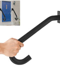 Close-up of a hand gripping a black U-shaped metal handrail mounted on a wall for safety, part of the Two Pack Half U Metal Handrails For Outdoor Steps And Indoor Stairs Wall Mount Safety Rail With Hardware Badass Grip For Elderly Rock Solid Build Smooth Install Heavy Duty Stair Support Rig.