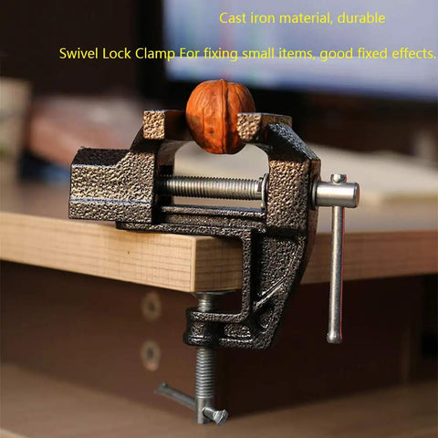 Handy Little 2.4 Inch Mini Table Clamp Bench Vise Made From Durable Cast Iron holding a walnut on a wooden table edge