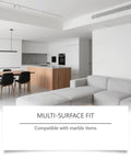 Modern kitchen and living area with gray sofa and wooden dining table, highlighting compatibility with marble items.