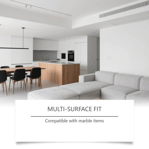 Modern kitchen and living area with gray sofa and wooden dining table, highlighting compatibility with marble items.